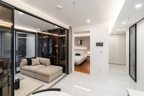 a living room with a couch and a bedroom at Le Collective Gangnam SAC Signity in Seoul