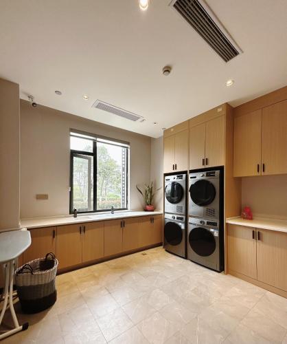 a large kitchen with two washer and dryer at SHANGHAI-DECO Hotel-Free shuttle bus to Pudong Airport and Disneyland in Shanghai