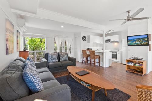 a living room with a couch and a table at Coco Bay Resort in Noosaville