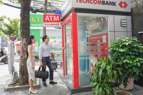 a man and a woman standing in front of a store at Hotel Soco in Da Nang