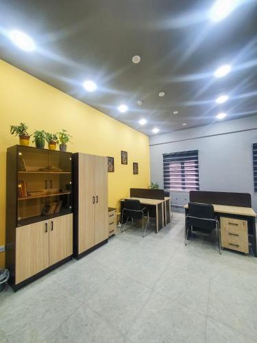 an office with two desks and two tables in a room at Safarov's Family Hostel in Tashkent