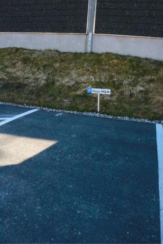 a street sign on the side of a parking lot at Haus M&M in Brixen im Thale