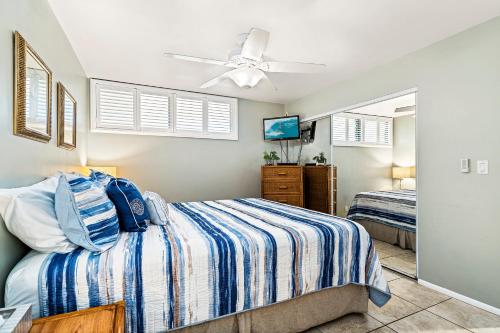 a bedroom with a bed and a ceiling fan at Sea Village 1105 in Kailua-Kona