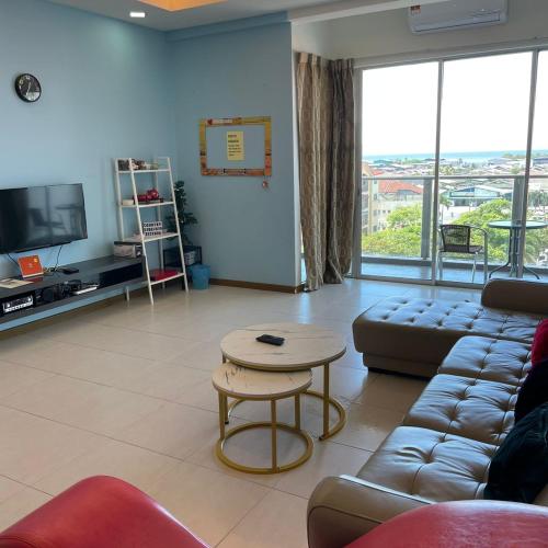 a living room with a couch and a table at Countryside Condo @One Residence Sekinchan in Sekincan