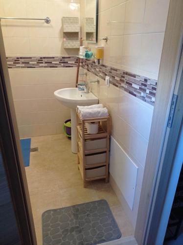 a bathroom with a sink and a toilet and a sink at Papas Apartments in Moírai