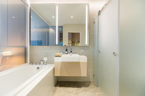 a bathroom with a sink and a shower at Arbour Hotel and Residence in Pattaya Central