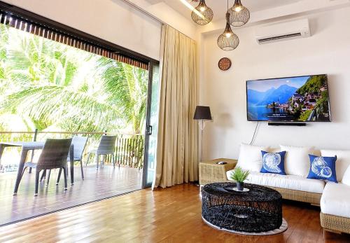 a living room with a couch and a table at Nacpan Beach Glamping in El Nido