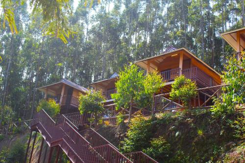 a row of cottages on a hill with stairs at CHEENI HILL RESORTS in Kanthalloor