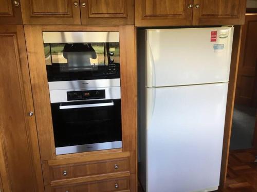 a white refrigerator and an oven in a kitchen at Old Entally Farm in Hadspen