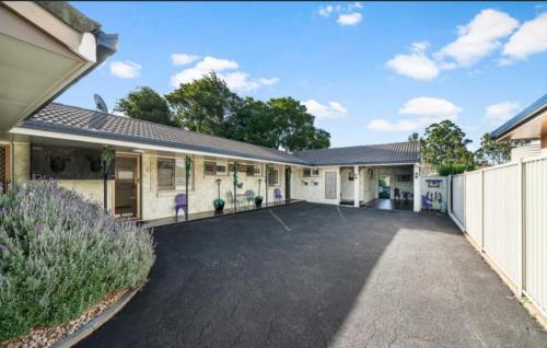an empty parking lot in front of a house at Toowoomba Hospital Apartments in Rockville