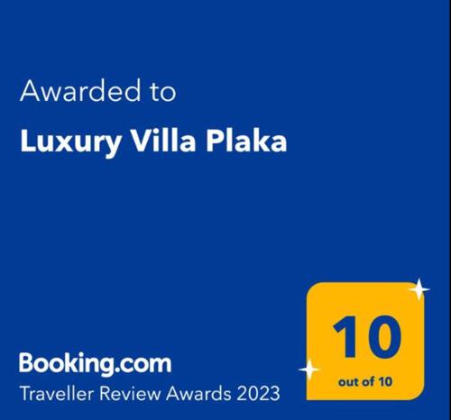 a yellow sign that reads awarded to luxury villa plaza at Luxury Villa Plaka Litochorou with Pool in Plaka Litochorou