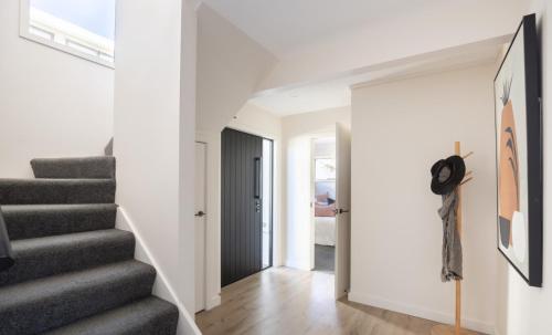 a hallway with stairs leading to a bedroom at City Apartments in Nelson