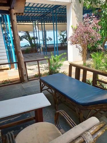 a table and chairs in front of a building at Peace Garden Beach Resort in Canacona
