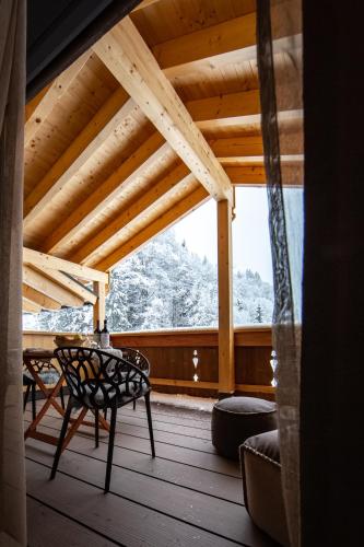 a wooden porch with a bench and a wooden roof at Brunnenhof Oberstdorf - Ferienwohnungen mit Hotel Service in Oberstdorf