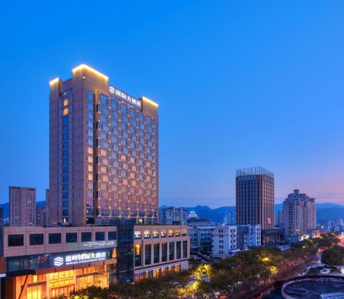 a tall building in a city at night at Wen Ling International Hotel in Wenling