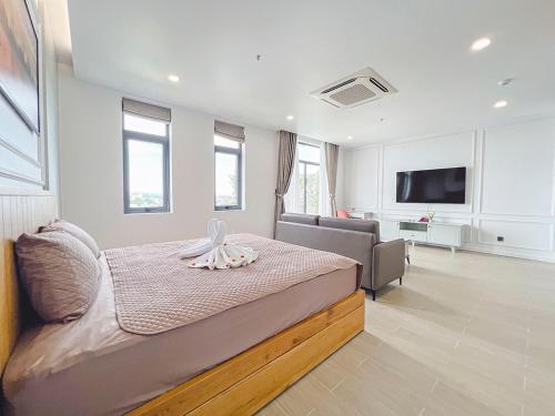 a bedroom with a bed and a living room at Lam's Beach Homestay in Phan Thiet
