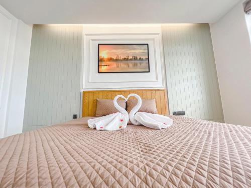 two swans are sitting on top of a bed at Lam's Beach Homestay in Phan Thiet