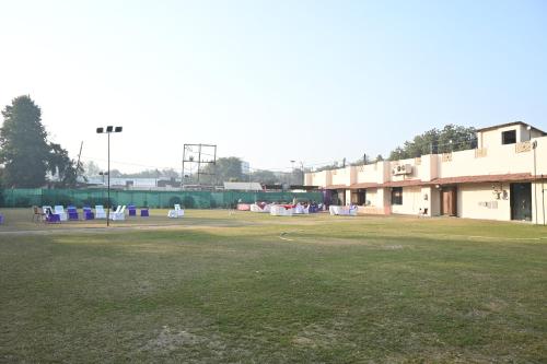 a large grass field in front of a building at Regency Square Hotel in Gwalior
