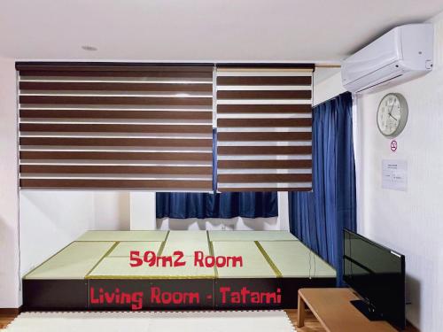 a bedroom with a large window with a bed and a television at Space Tokyo House in Tokyo