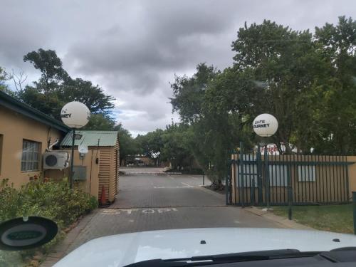 a car parked next to a fence with two balls on it at 86 Pendleberry Holiday Grove in Warmbaths