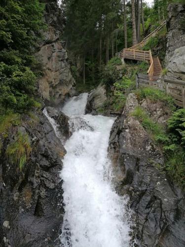 a waterfall on the side of a rocky mountain at Haus Grünfels ApARTment in Murau