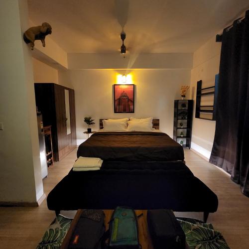 a bedroom with two beds and luggage on the floor at The Nest Lucknow in Lucknow