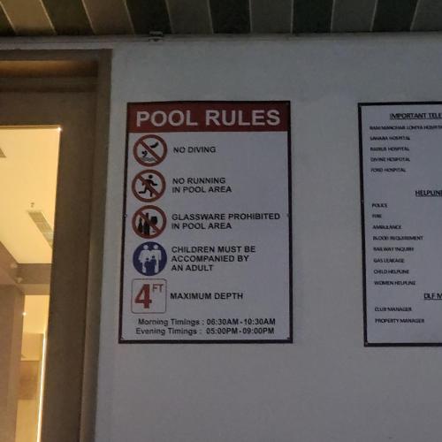 a sign that says pool rules on a wall at The Nest Lucknow in Lucknow