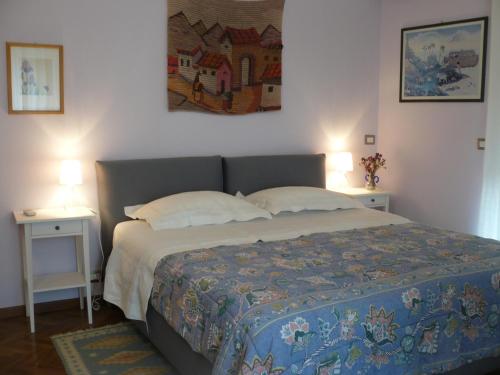 a bedroom with a bed with two tables and two lamps at B&B VELARDI in Viagrande