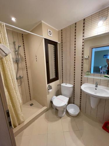 a bathroom with a toilet and a sink at Green Life apartment Sozopol in Sozopol
