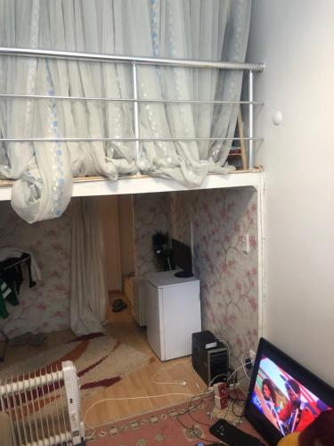 a bedroom with a bunk bed with a laptop on the floor at • Beachside Flat Entrance Flat With Mezzanine Floor ~~ Asma Katlı Sahil Yanı Düz Giriş Daire • in Istanbul