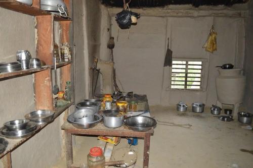 a kitchen with pots and pans on a table at Bhada Community Homestay 