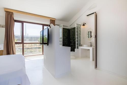 a living room with a tv on a wall at 777 Alaçatı Adults only in Alacati