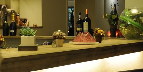 a counter with a bunch of bottles of wine at Hotel Escapade in De Haan