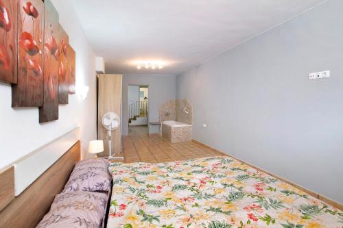 a bedroom with a large bed and a bathroom at Montemar 2 in Moya