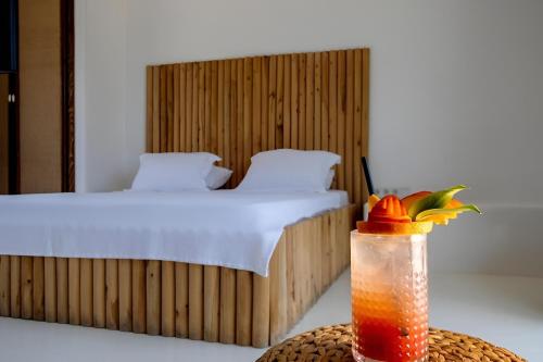 a bedroom with a bed and a drink in a bottle at 777 Alaçatı Adults only in Alacati