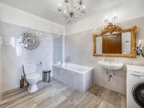 a bathroom with a sink and a tub and a toilet at Brilliant apartment in Château du Châtelard in Montreux