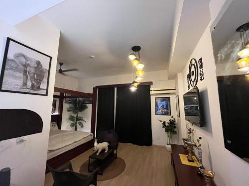 a room with a bedroom with a bed and a dog at The Nest Lucknow in Lucknow