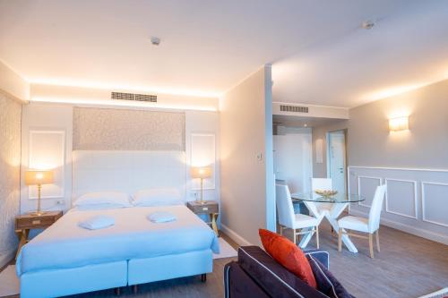 a hotel room with a bed and a dining room at Borgo Le Terrazze in Bellagio