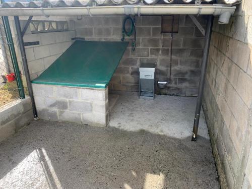a dugout with a green bench in a brick wall at La Buhardilla De Solavega - VV2530AS in Sevares