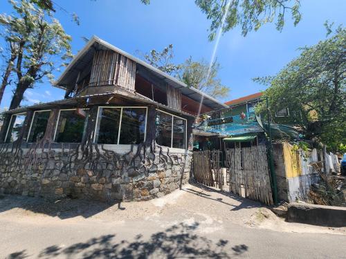 a stone building with a fence in front of it at Wildways Mudumalai Homestay in Masinagudi