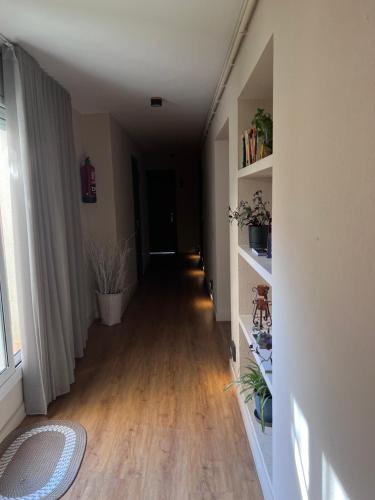 a hallway of a room with a hard wood floor at Hostal Crisami in Solsona