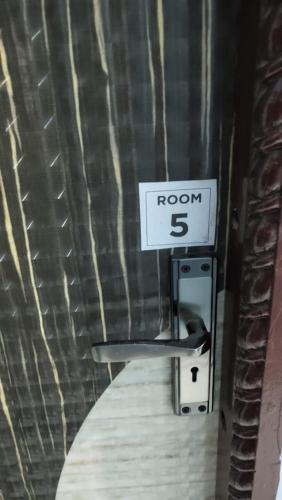 a room sign on a wall with a room sign at Sagarika Guest House in Kānki
