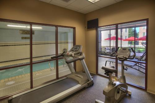 a gym with a treadmill and a view of a pool at The Hotel Warner in West Chester