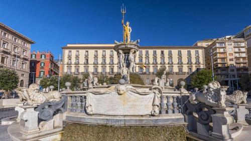 a fountain in front of a large building at SILIA HOUSE Napoli Centro in Naples
