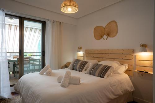 a bedroom with a large white bed with pillows at MENDILAUTA in Zarautz