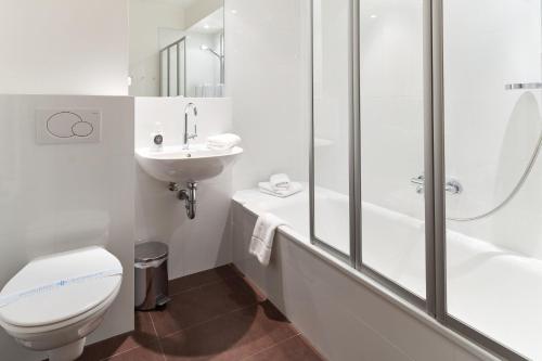 a bathroom with a toilet and a sink and a shower at Strandresidenz Timmendorfer Strand Apartment 215 in Timmendorfer Strand
