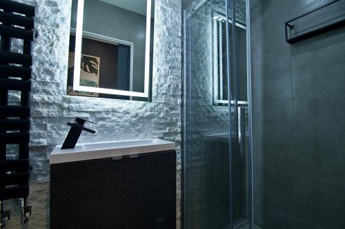 a bathroom with a sink and a glass shower at 'Bellerose' at stayBOOM in Scotforth