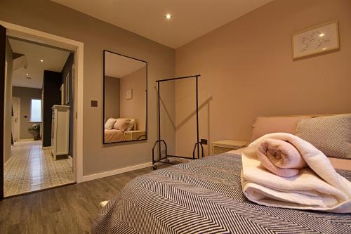 a bedroom with a bed with a towel on it at 'Bellerose' at stayBOOM in Scotforth