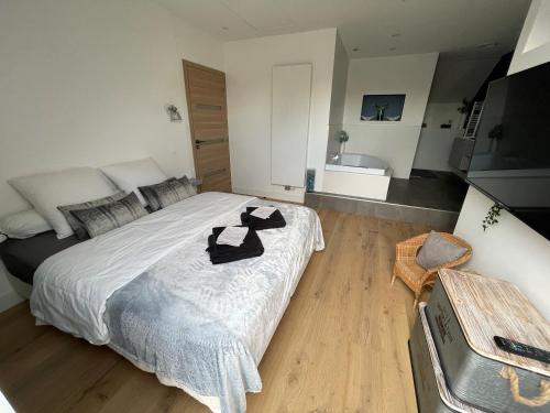 a bedroom with a bed with black shoes on it at Chambre proche centre avec petit déjeuner in Fontaine-lès-Dijon