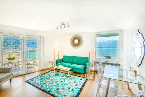 a living room with a green couch and a table at Montreux paradise top view in Montreux